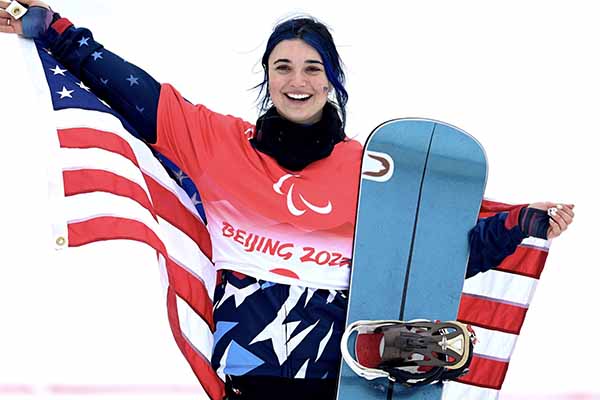 Photo of Brenna Huckaby holding the American flag.